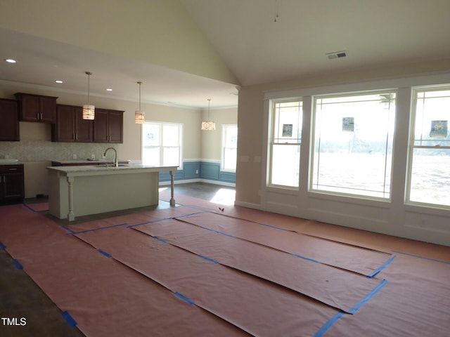 interior space featuring crown molding, lofted ceiling, and sink