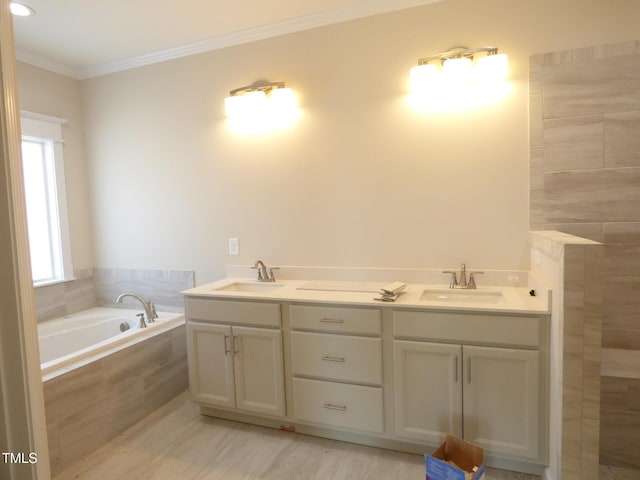 bathroom with vanity, a relaxing tiled tub, and ornamental molding