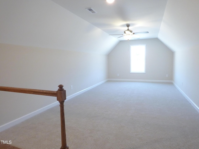 bonus room with lofted ceiling, light carpet, and ceiling fan