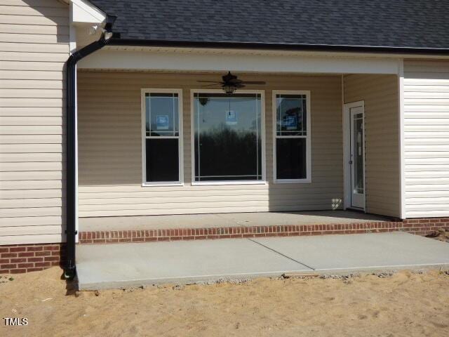 doorway to property featuring a patio area and ceiling fan