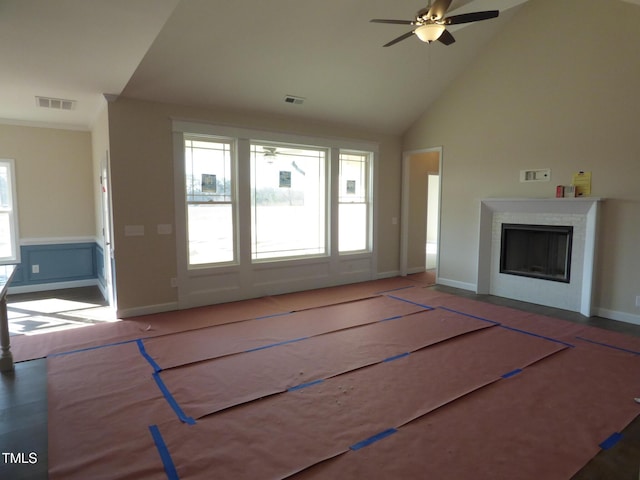 unfurnished living room featuring ceiling fan and high vaulted ceiling