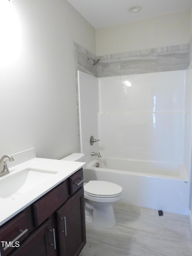 full bathroom featuring vanity, washtub / shower combination, and toilet