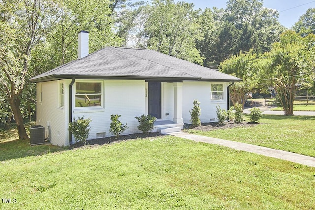 view of front facade with central AC and a front lawn