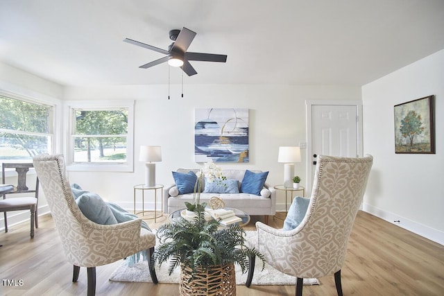 living room with ceiling fan and light wood-type flooring