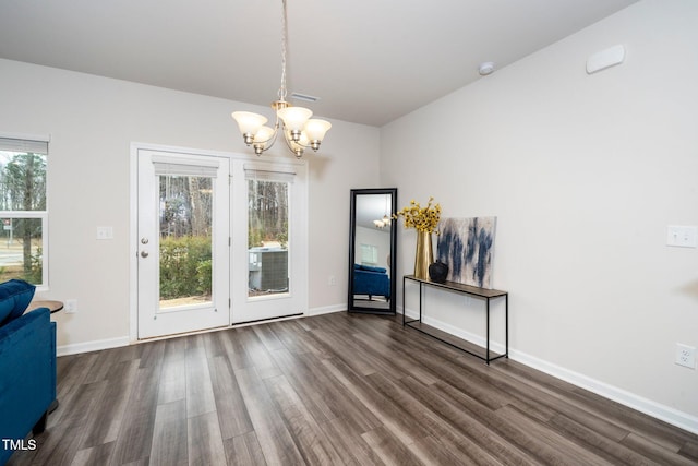 interior space with dark hardwood / wood-style flooring and a notable chandelier