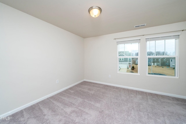 empty room featuring light carpet