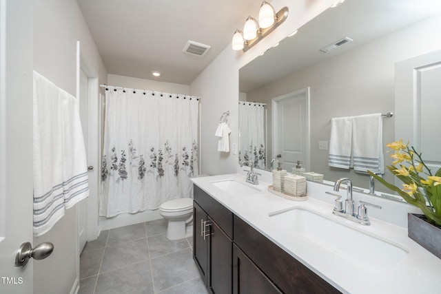 full bathroom with tile patterned floors, toilet, shower / bath combo with shower curtain, and vanity