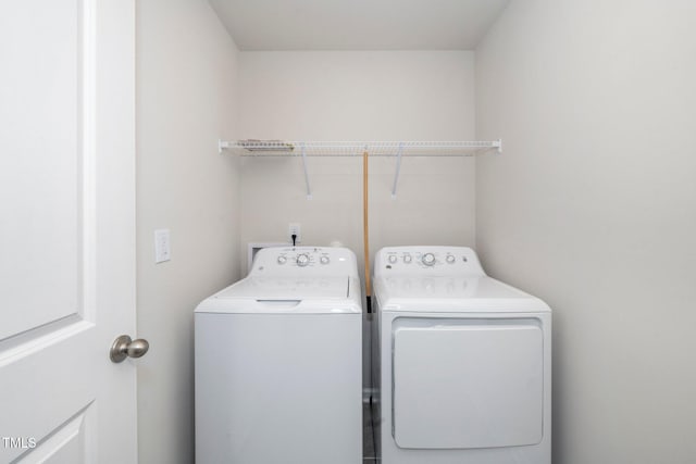 laundry area featuring washing machine and clothes dryer