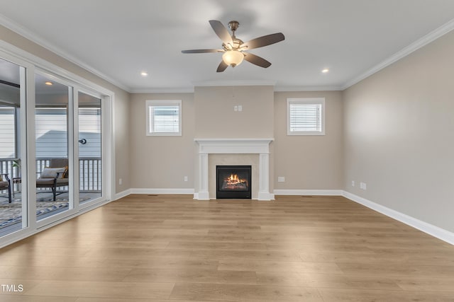 unfurnished living room with a wealth of natural light, light wood-style flooring, and baseboards