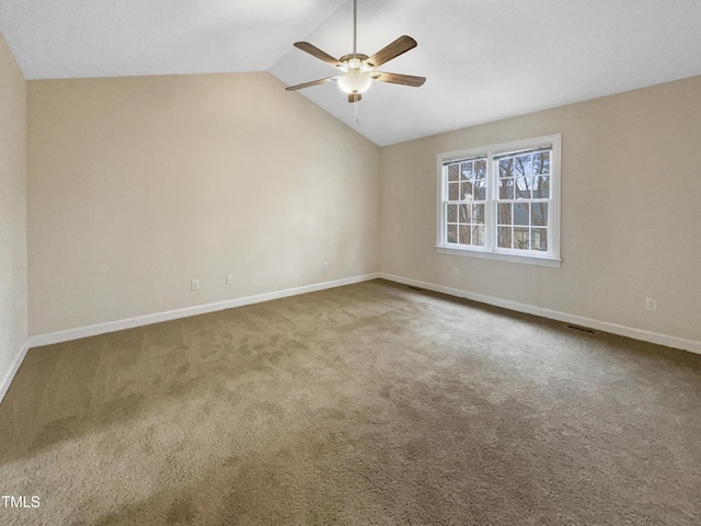 carpeted spare room featuring lofted ceiling and ceiling fan