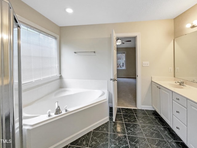 bathroom featuring vanity and a washtub