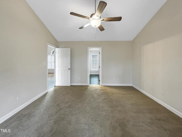 carpeted spare room featuring ceiling fan and lofted ceiling