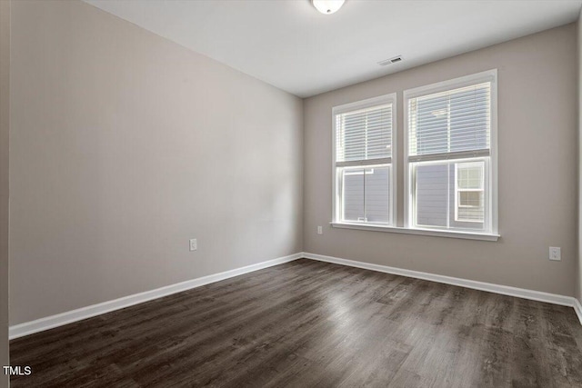 spare room with dark hardwood / wood-style floors