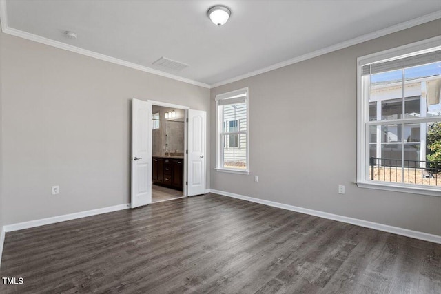 empty room with dark hardwood / wood-style flooring and ornamental molding