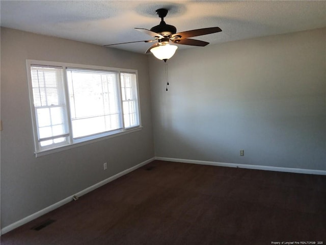 spare room featuring a textured ceiling and ceiling fan