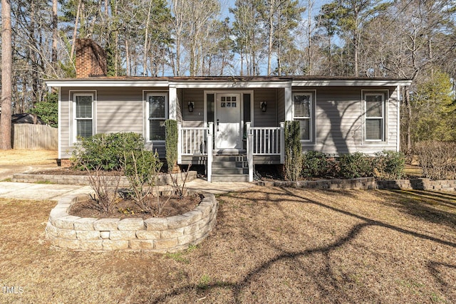 ranch-style house featuring a porch and a front yard