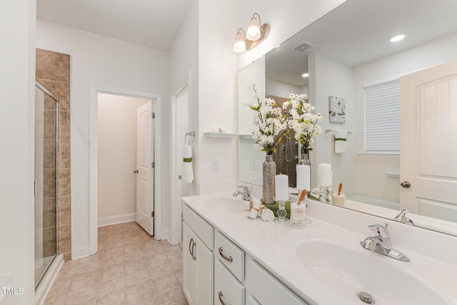 bathroom with tile patterned floors, vanity, and an enclosed shower