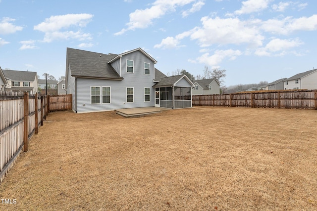 back of house featuring a sunroom, a lawn, and a patio area