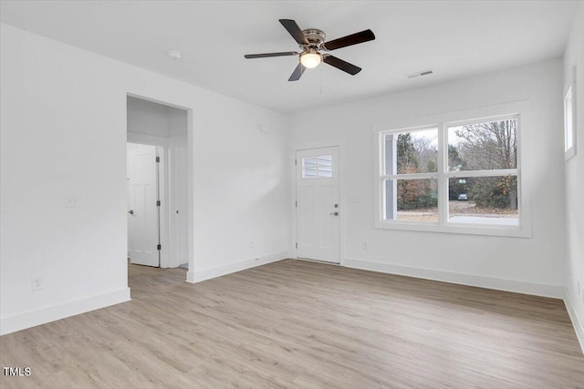 empty room with light hardwood / wood-style floors and ceiling fan