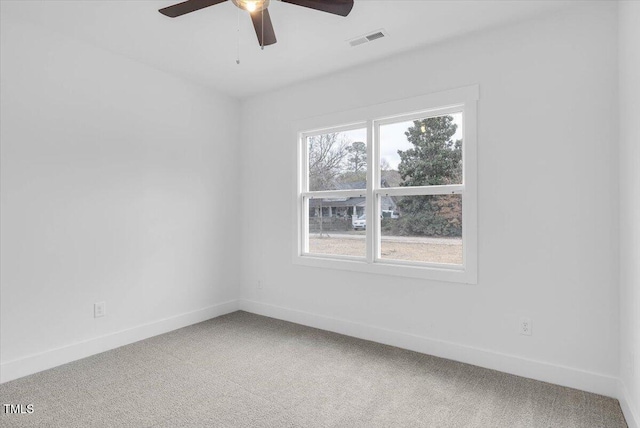 empty room featuring carpet floors and ceiling fan