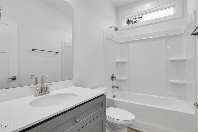 full bathroom featuring toilet, vanity, and bathtub / shower combination