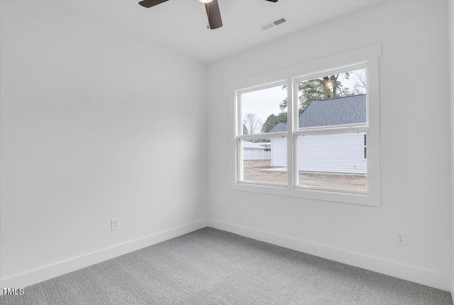 empty room with ceiling fan and carpet