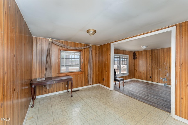 misc room featuring wood walls