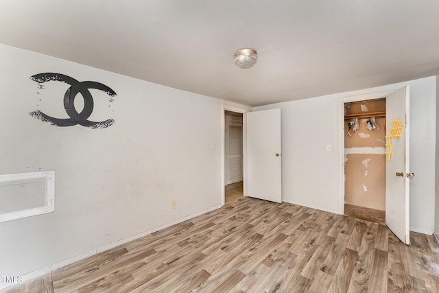 unfurnished bedroom featuring light wood-type flooring