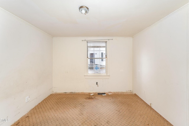 unfurnished room with crown molding