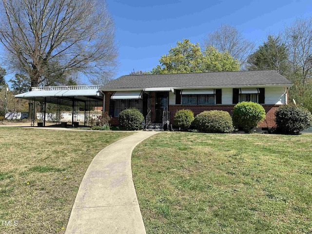 view of front facade featuring a front lawn and a carport