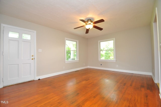 foyer entrance featuring dark wood-type flooring and ceiling fan