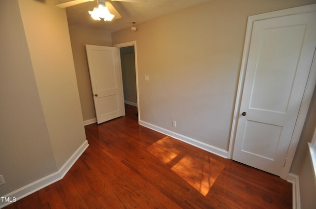 unfurnished bedroom with dark hardwood / wood-style floors and ceiling fan