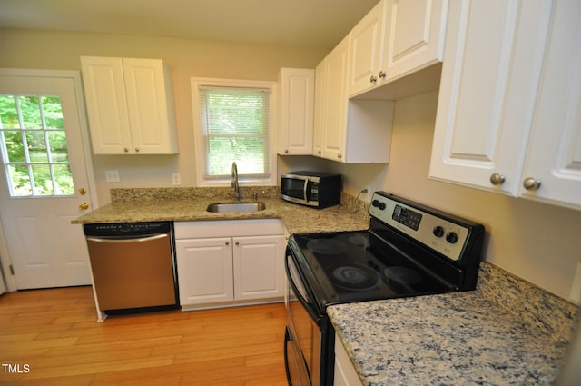 kitchen with white cabinetry, sink, plenty of natural light, and appliances with stainless steel finishes