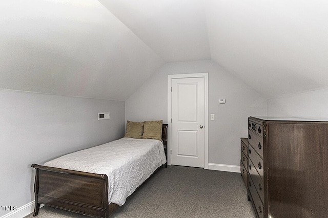 bedroom with lofted ceiling and dark carpet