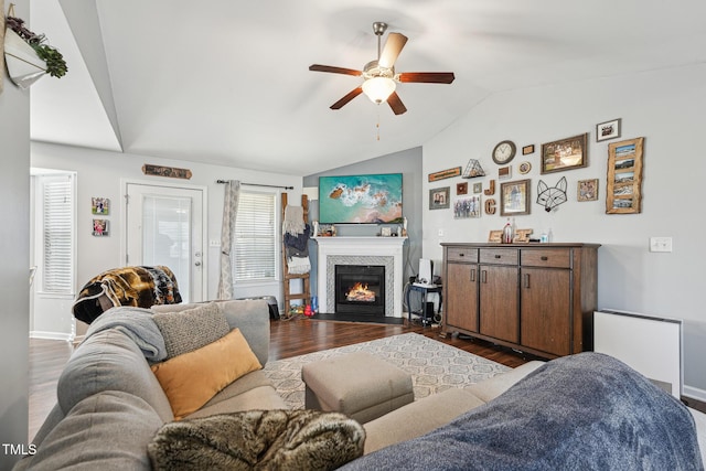 living room featuring vaulted ceiling, dark hardwood / wood-style floors, radiator heating unit, and ceiling fan