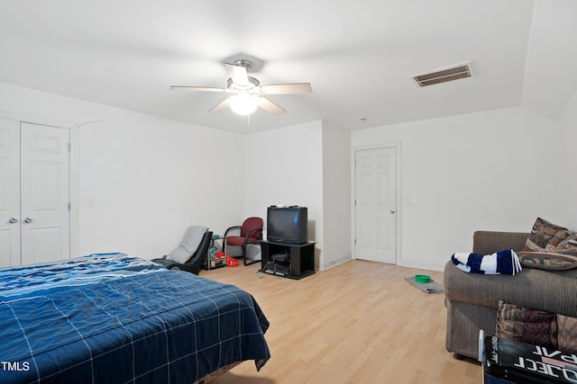 bedroom with lofted ceiling, hardwood / wood-style floors, and ceiling fan