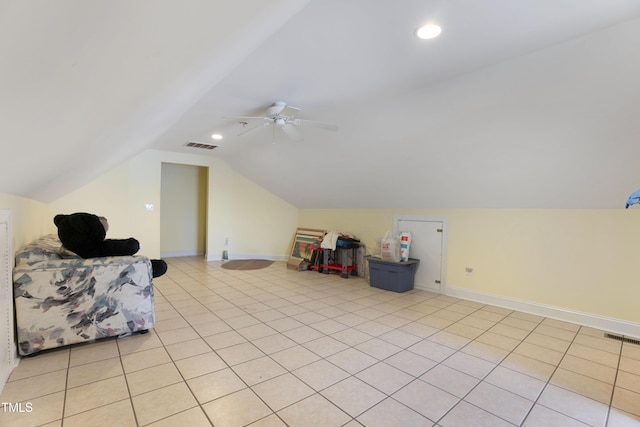 additional living space with ceiling fan, vaulted ceiling, and light tile patterned floors