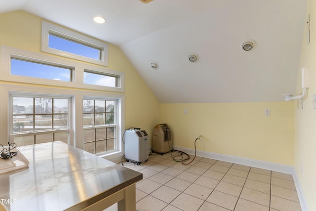 additional living space with vaulted ceiling and light tile patterned floors