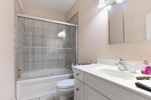 full bathroom with vanity, combined bath / shower with glass door, tile patterned floors, and toilet