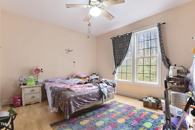 bedroom with ceiling fan and light wood-type flooring