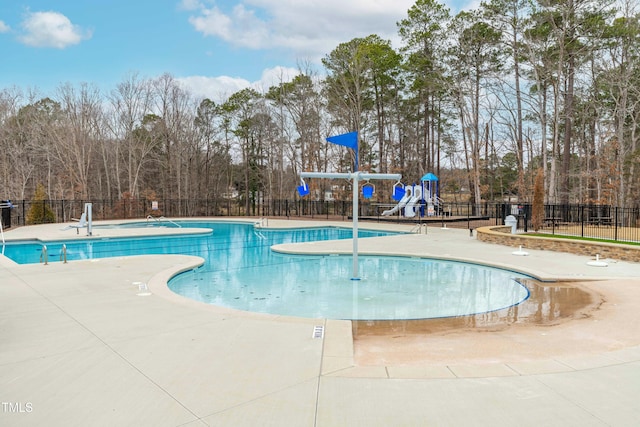 view of swimming pool with a patio and a playground