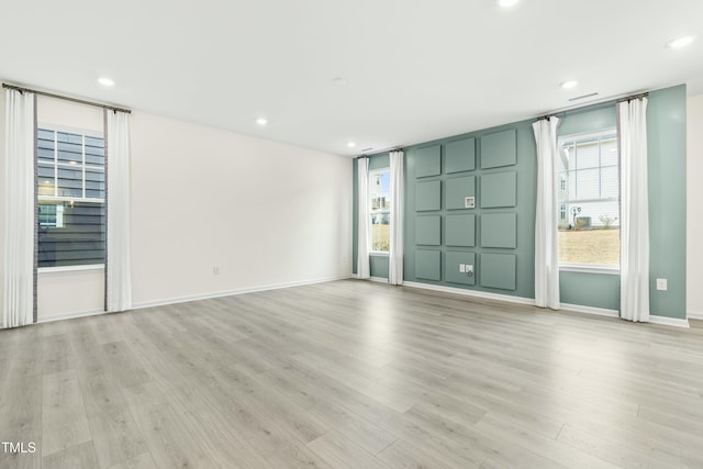 unfurnished room with light hardwood / wood-style floors