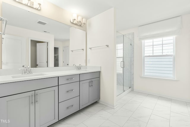 bathroom featuring an enclosed shower and vanity