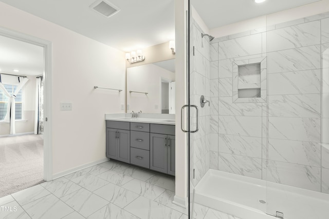 bathroom with vanity and a shower with shower door