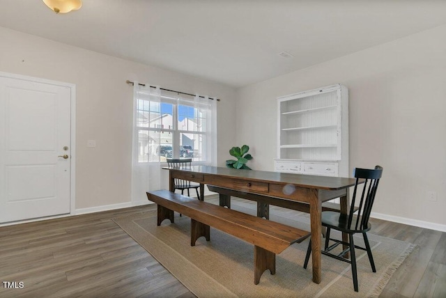 dining room with wood finished floors and baseboards