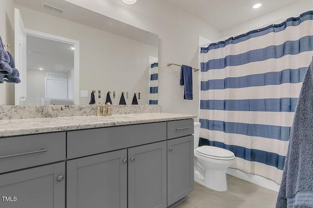 bathroom with vanity, tile patterned floors, and toilet