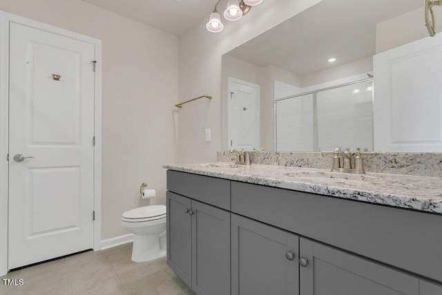 bathroom with vanity, toilet, a shower with shower door, and tile patterned flooring