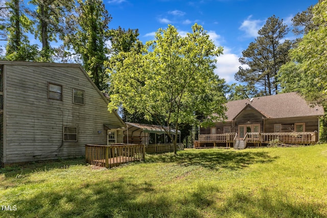 view of yard featuring a wooden deck and a carport