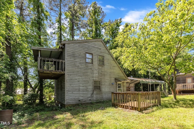 view of side of home featuring a balcony, a yard, and a deck