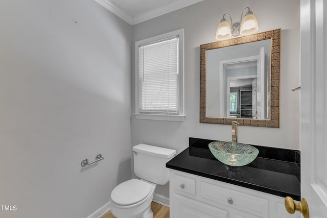 bathroom featuring crown molding, toilet, baseboards, and vanity